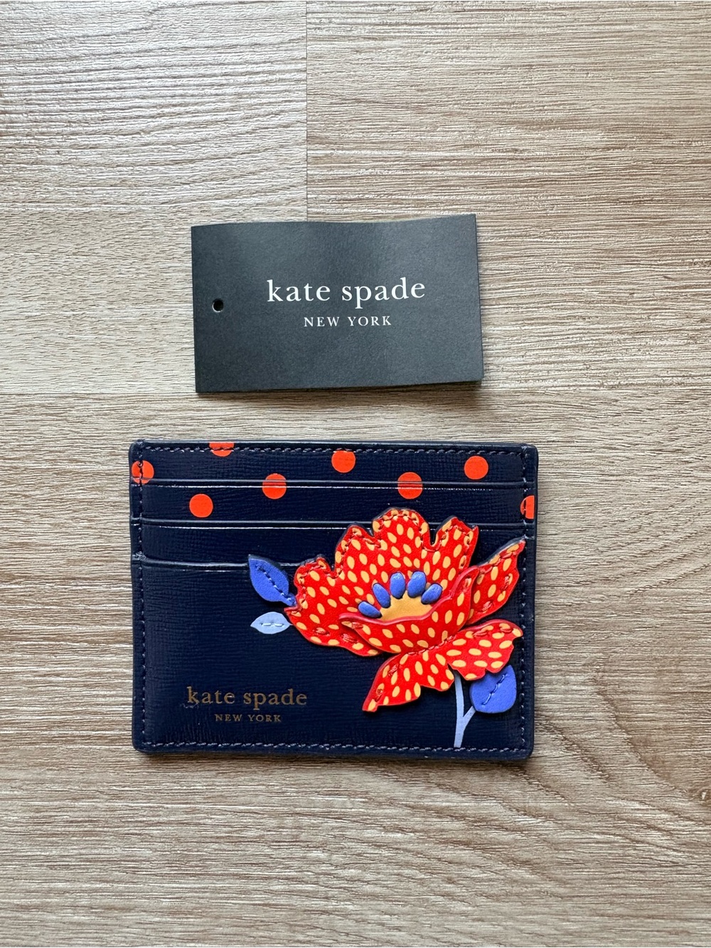 Kate Spade navy card holder with red floral applique and orange polka dots - Picture 2 of 5